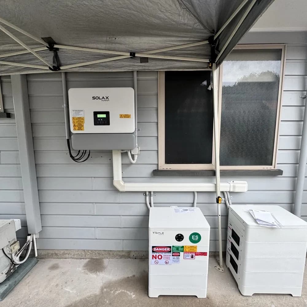 SolaX hybrid inverter with two Triple Power battery stacks installed by Nuvolt on the outside wall of a Coolum Beach home