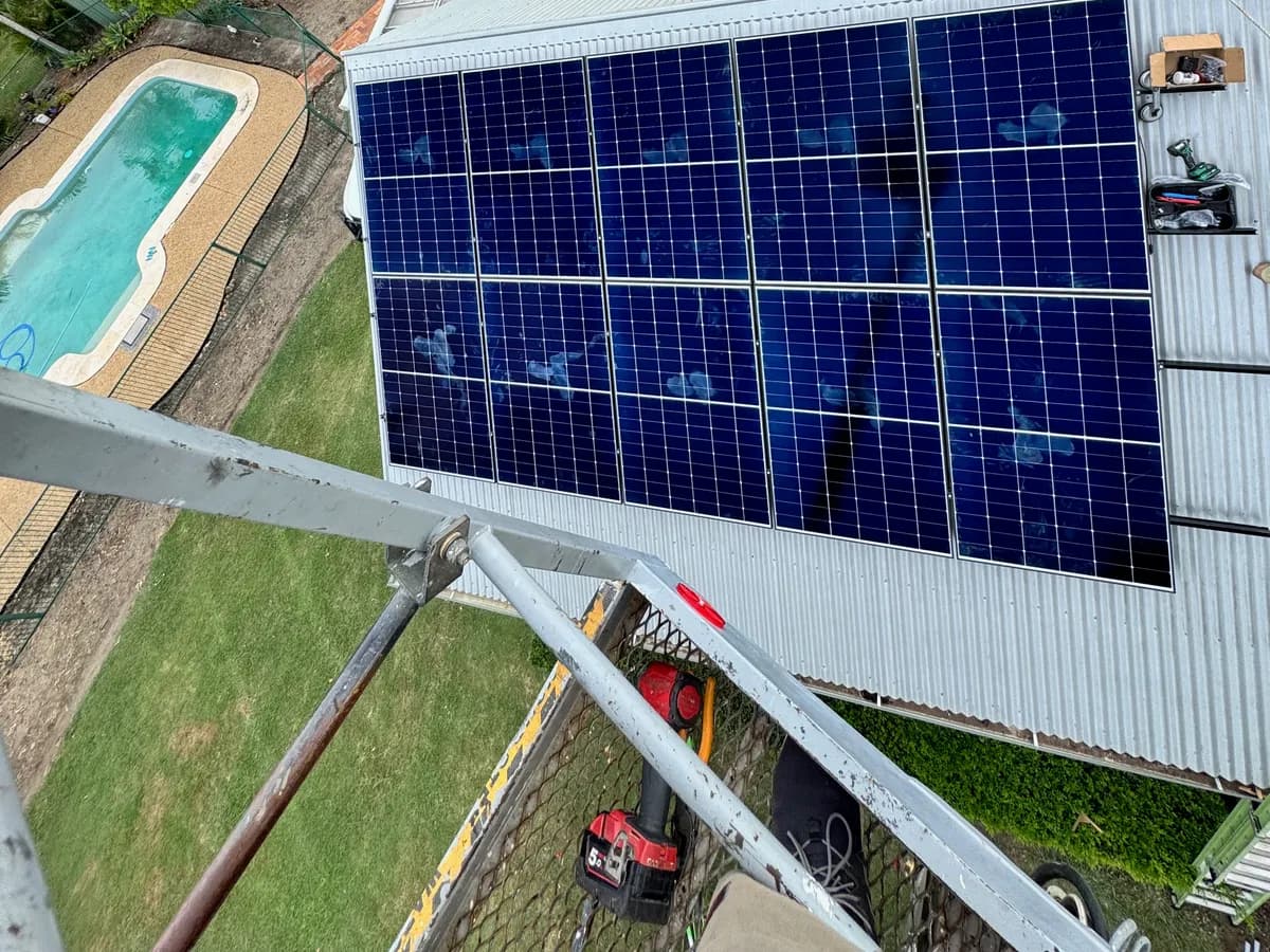 Rooftop solar array overlooking a backyard pool