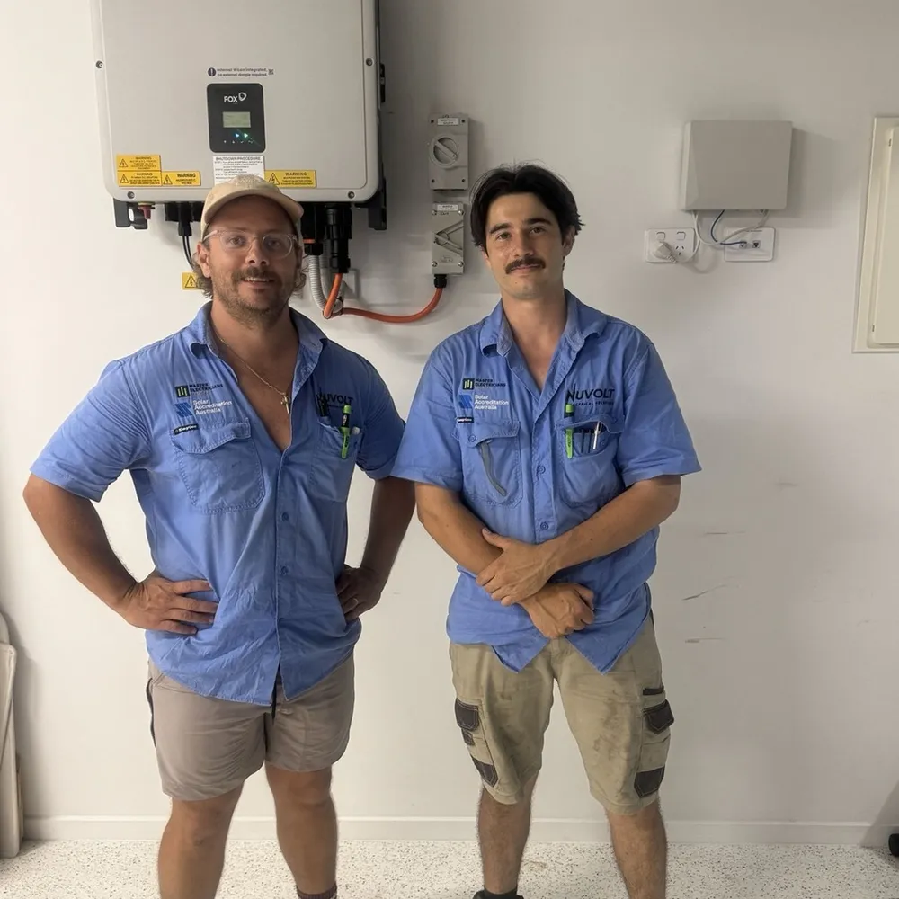 The Nuvolt Electrical team on site beside a completed switchboard and inverter install